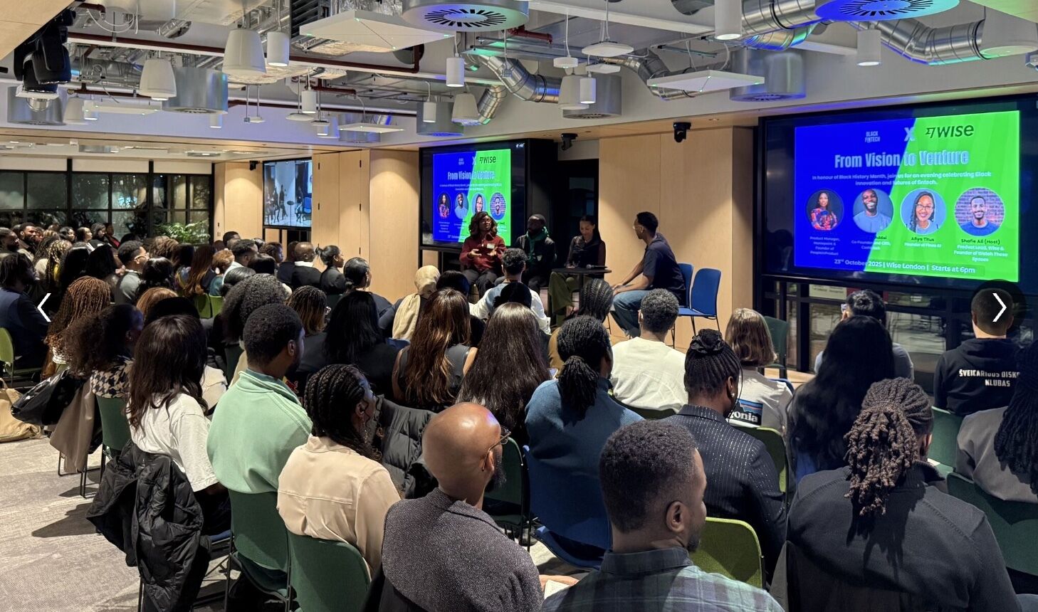 From Vision to Venture - Black in Fintech event at Wise London with panellists on stage